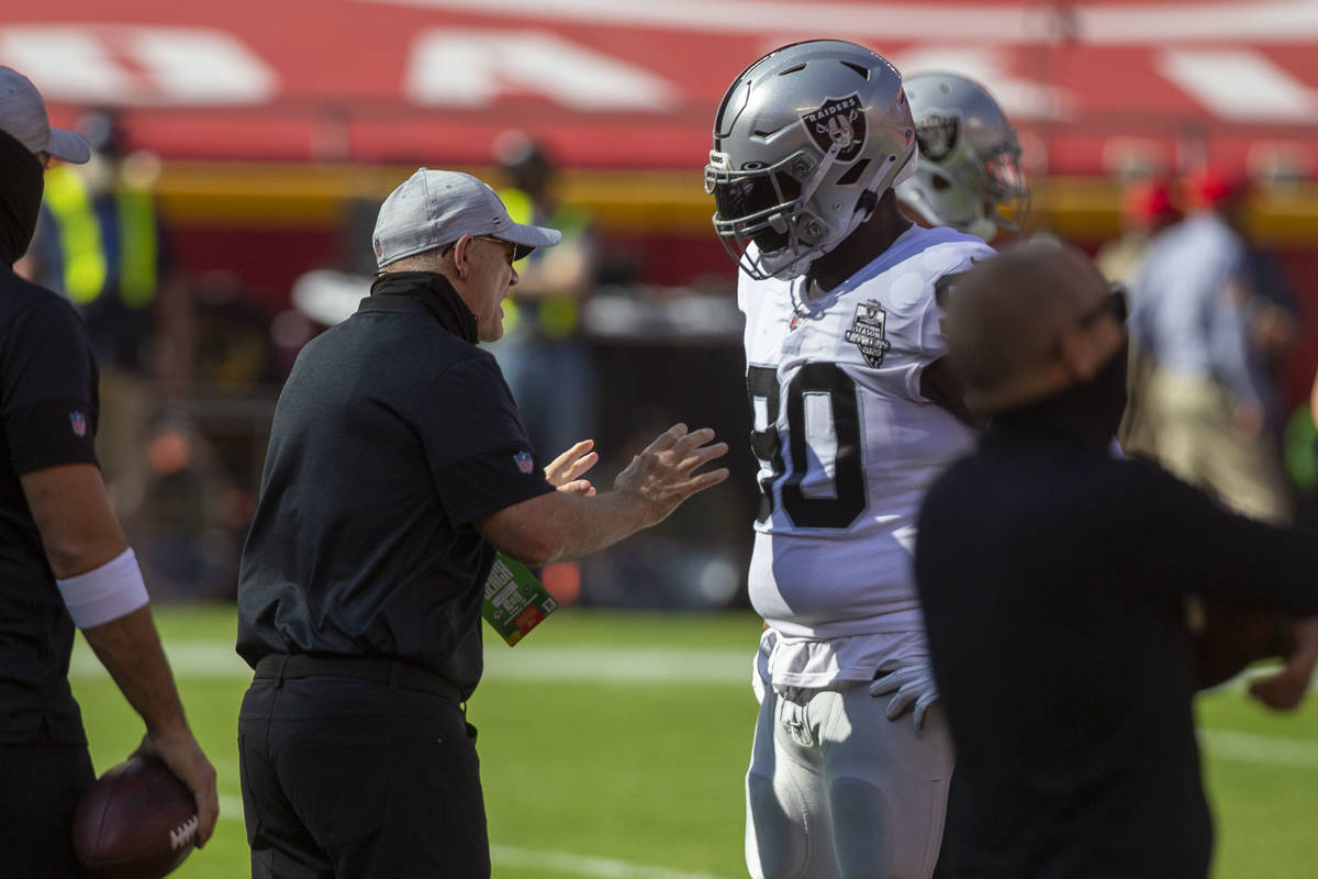 Las Vegas Raiders defensive line coach Rod Marinelli, left, coaches defensive tackle Johnathan ...