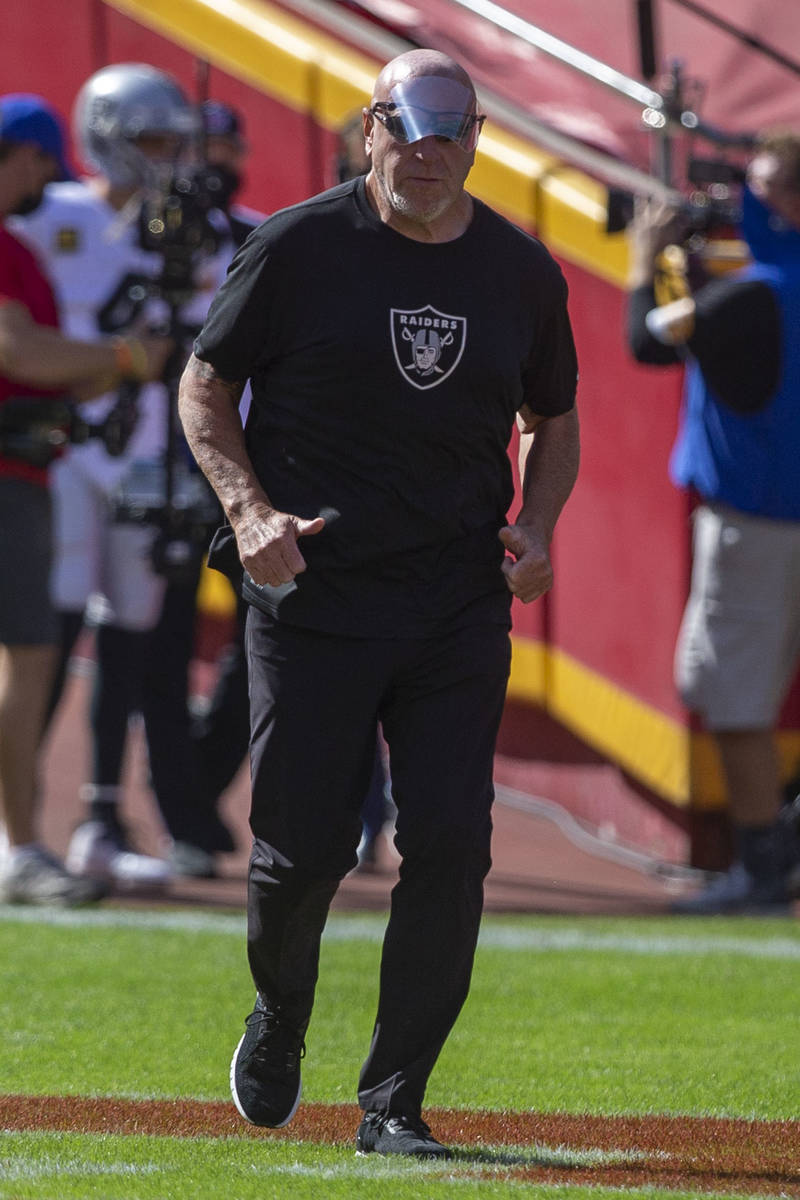 Las Vegas Raiders offensive line coach Tom Cable runs on the field before an NFL football game ...