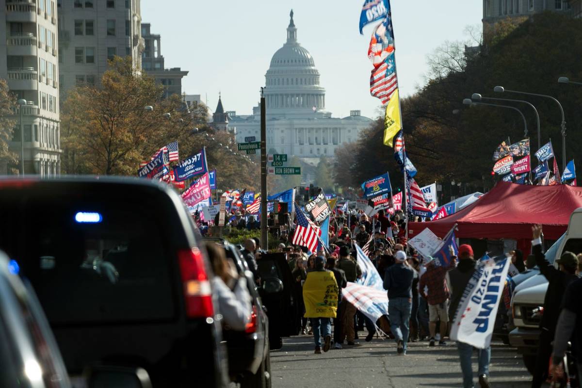 President Donald Trump drives by a group of supporters participating in a rally near the White ...
