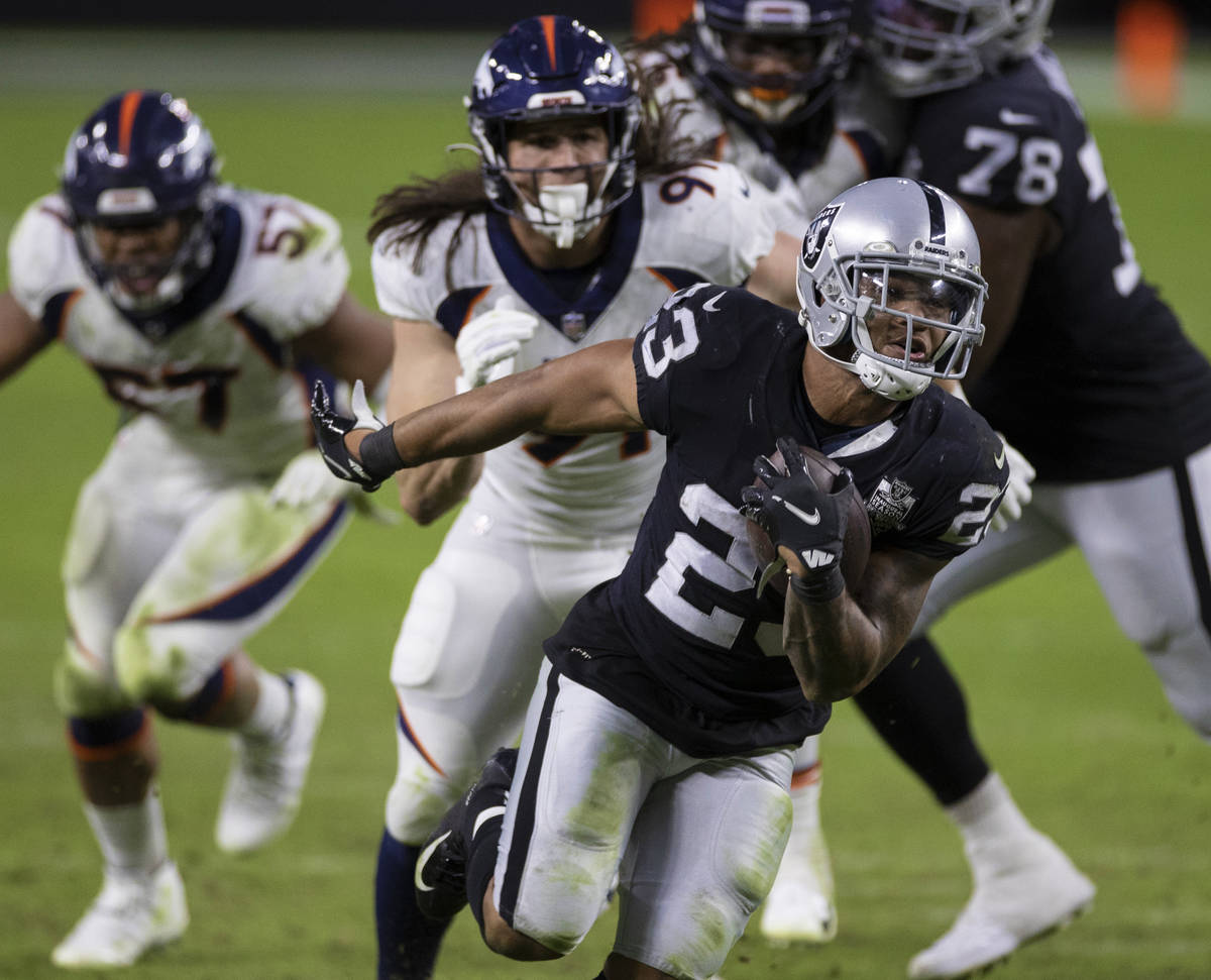 Las Vegas Raiders running back Devontae Booker (23) sprints up field past Denver Broncos lineba ...