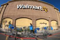 Shopping carts are lined up as barriers leading to the entrance of Walmart Supercenter in North ...