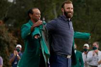 Tiger Woods, left and Dustin Johnson during the final round of the Masters golf tournament Mond ...