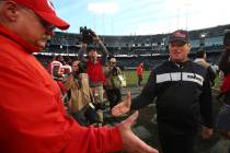 Kansas City Chiefs head coach Andy Reid, left, shakes hands with Oakland Raiders head coach Jon ...