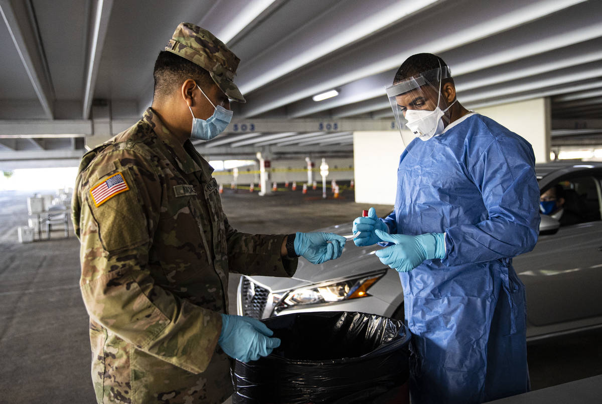 Nevada National Guard specialists Jonathan Macias, left, and Demetrie Barnett prepare to store ...