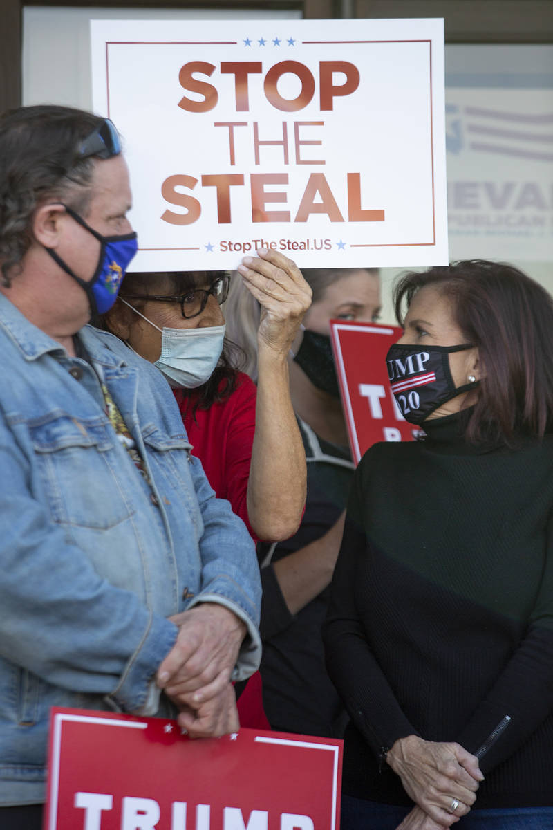 Supporters of Donald Trump attend a Nevada GOP press conference announcing a new elections laws ...