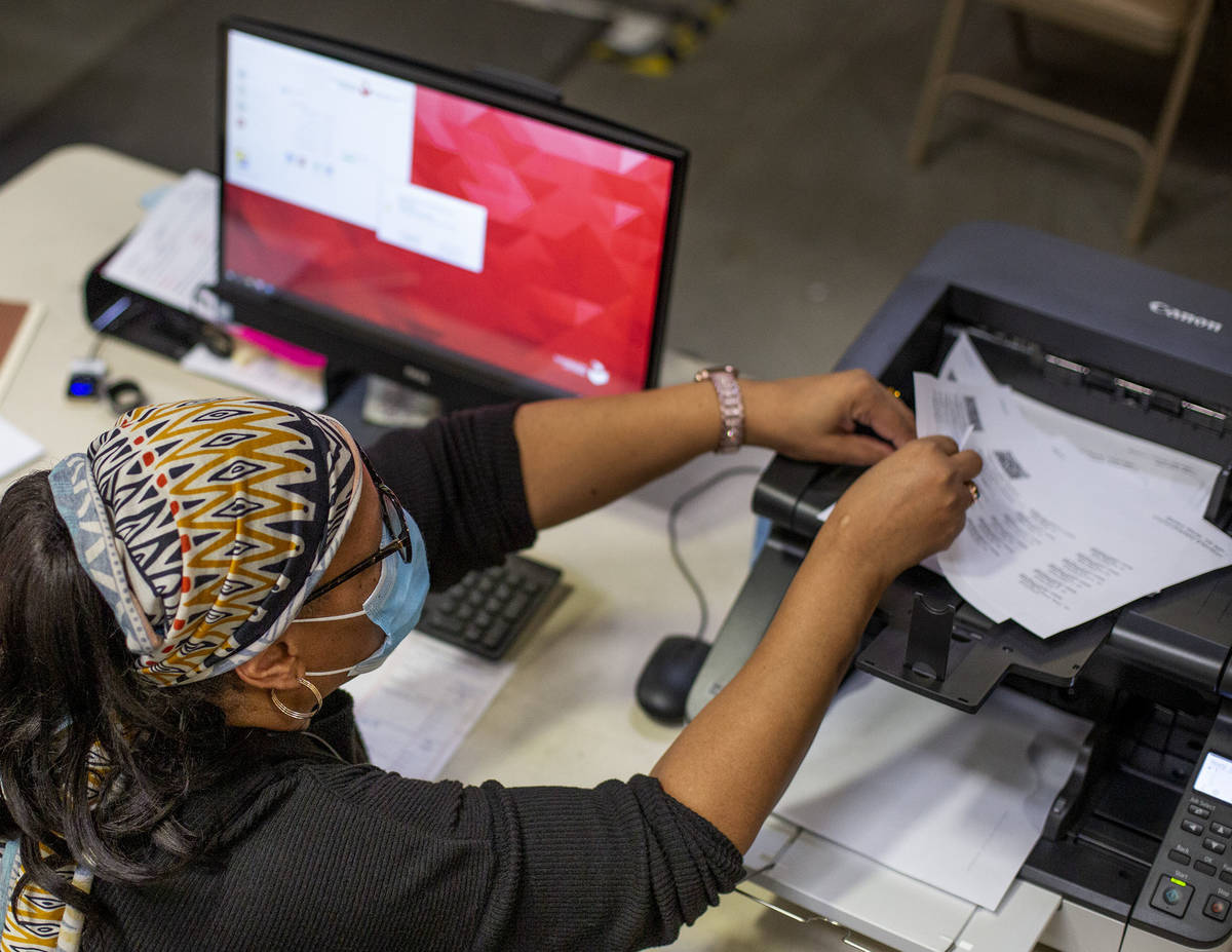 Mail-in ballots are counted at Clark County Election Center on Wednesday, Nov. 4, 2020, in Las ...
