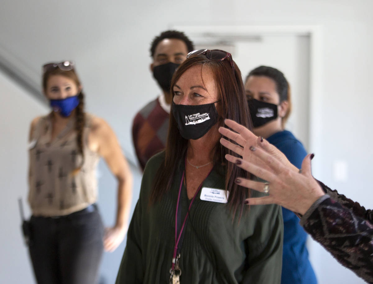 Staff members of the Las Vegas Rescue Mission, including shelter assistant Bonnie Powers, cente ...