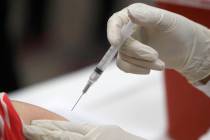 In this Thursday, Jan. 23, 2020 file photo, a patient receives an influenza vaccine in Mesquite ...