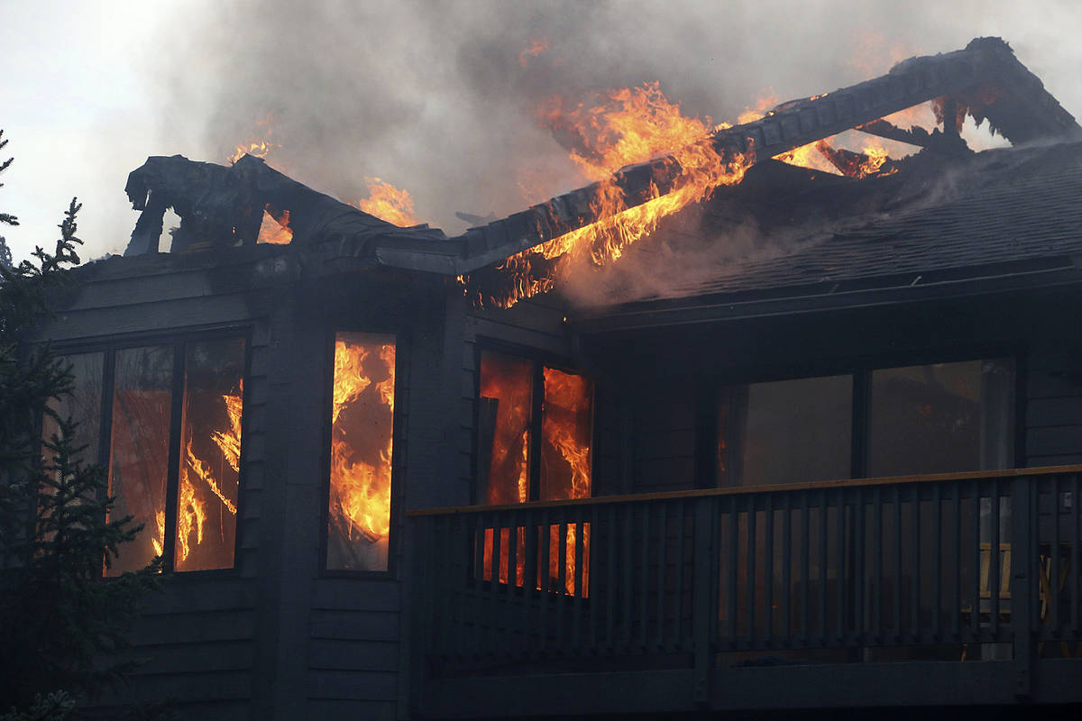 A home burns during the Pinehaven Fire in the Caughlin Ranch area of Reno, Nev., on Tuesday, No ...