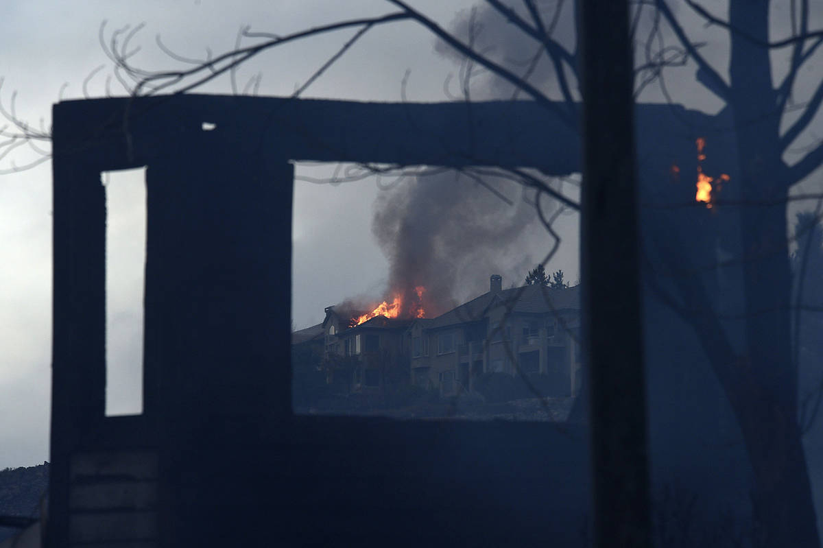 A large home burns during the Pinehaven Fire in the Caughlin Ranch area of Reno, Nev., on Tuesd ...