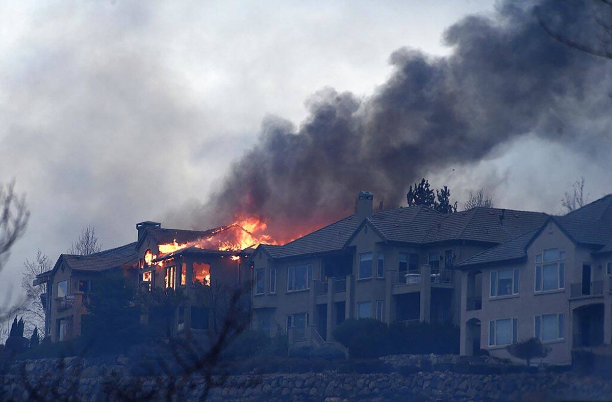 A large home burns during the Pinehaven Fire in the Caughlin Ranch area of Reno, Nev., on Tuesd ...