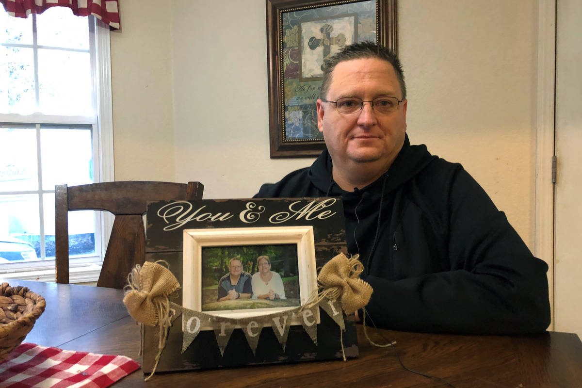 Keith Michael holds a photo on Friday, Nov. 13, 2020, in Jonesboro, Ark., of him and his wife, ...