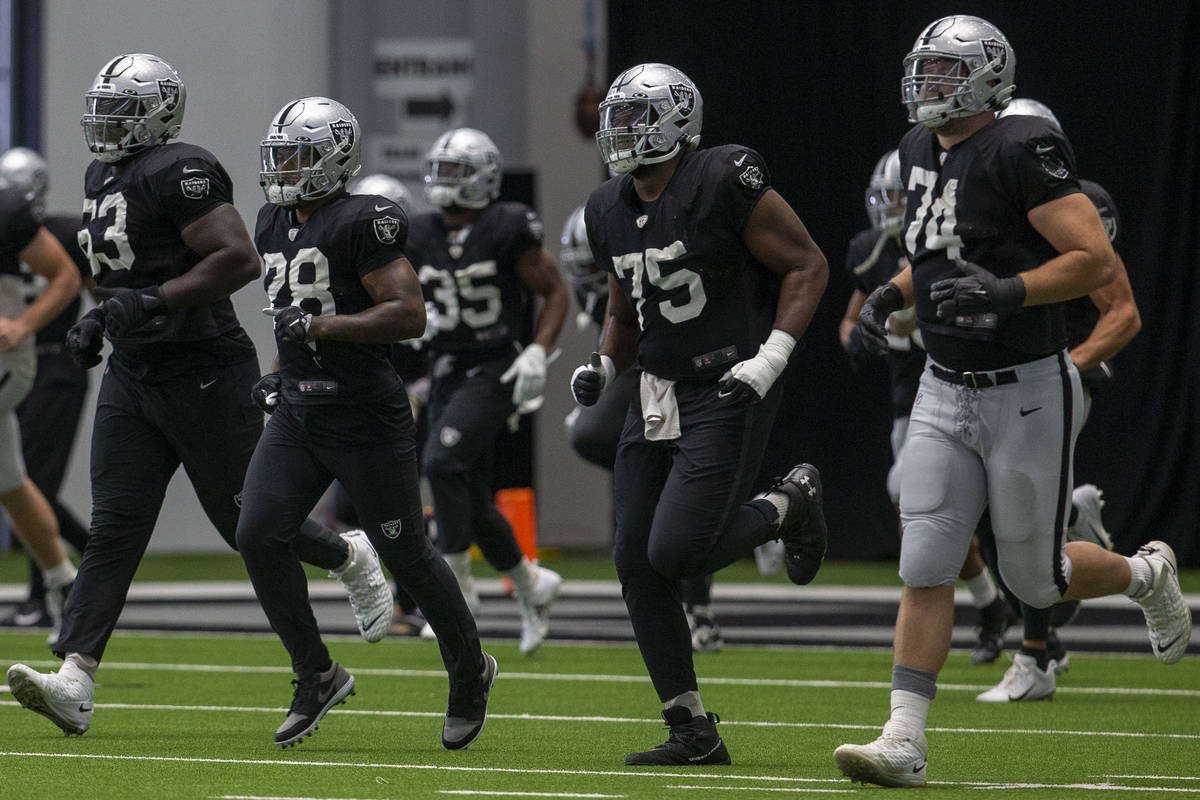 Las Vegas Raiders offensive tackle Kamaal Seymour (63), running back Josh Jacobs (28), offensiv ...