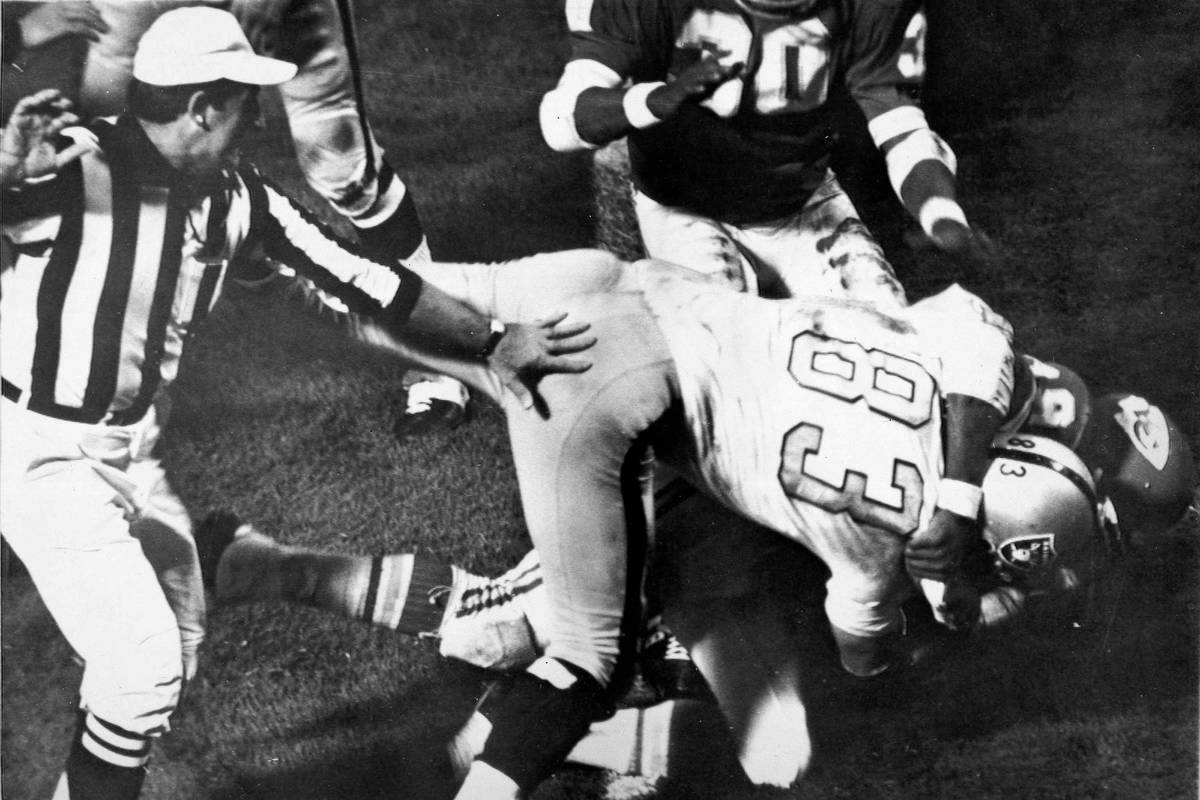 Otis Taylor of the Kansas City Chiefs, underneath, grabs Ben Davidson, on  top, of the Oakland R …