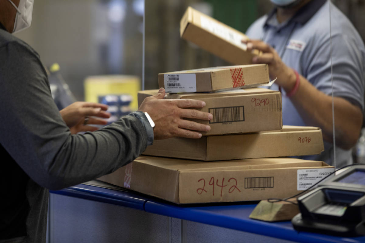Packages are dropped off to ship at the Spring Valley United States Postal Service, in Las Vega ...