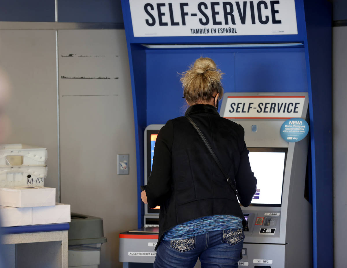 A customer uses a self-serve kiosk at the main Las Vegas Post Office on Sunset Road Wednesday, ...