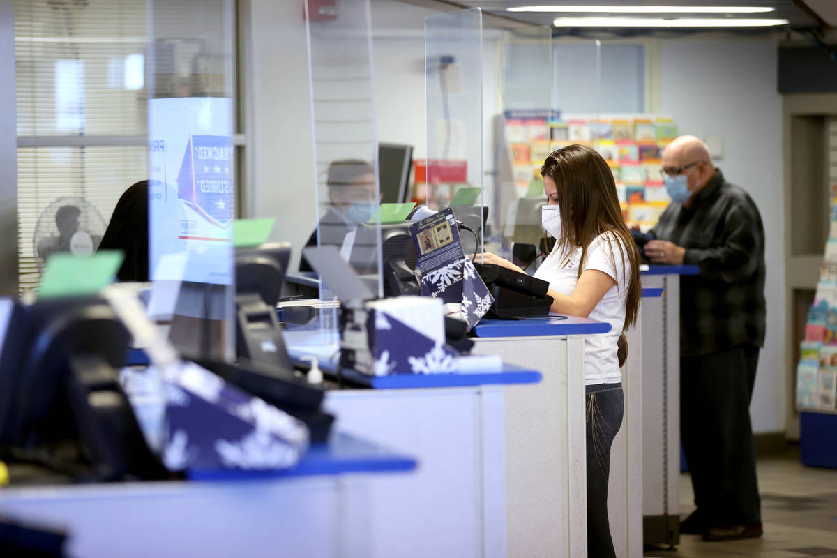 Clerks help customers at the main Las Vegas Post Office on Sunset Road Wednesday, Nov. 25, 2020 ...