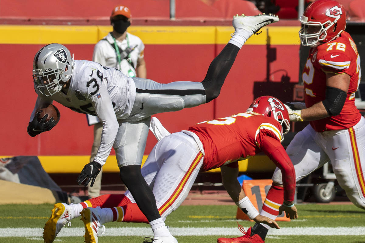 Las Vegas Raiders strong safety Jeff Heath (38) leaps over Kansas City Chiefs quarterback Patri ...