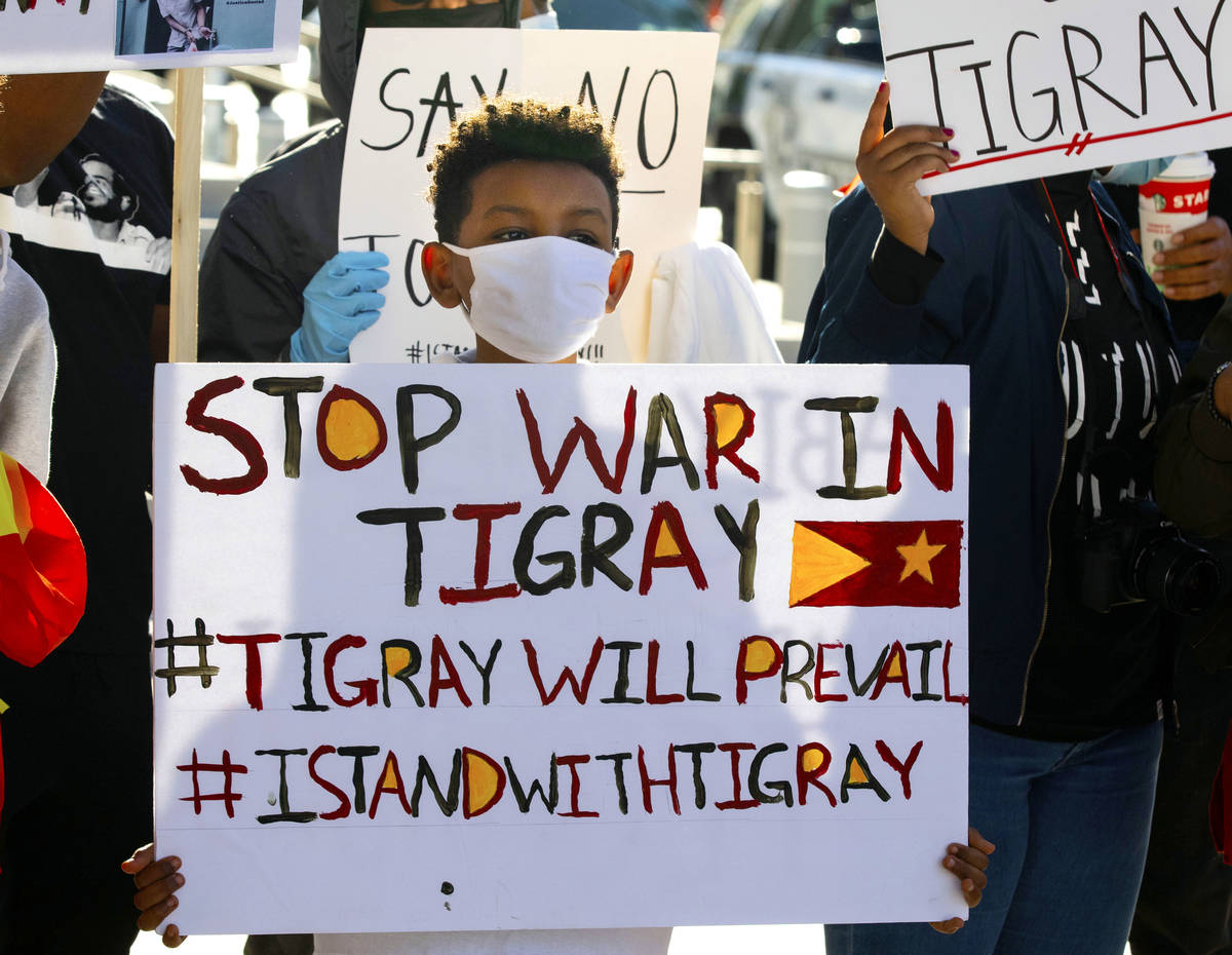 Yared Abraha, 11, holds a sign outside of the Lloyd D. George Federal Courthouse as he protests ...