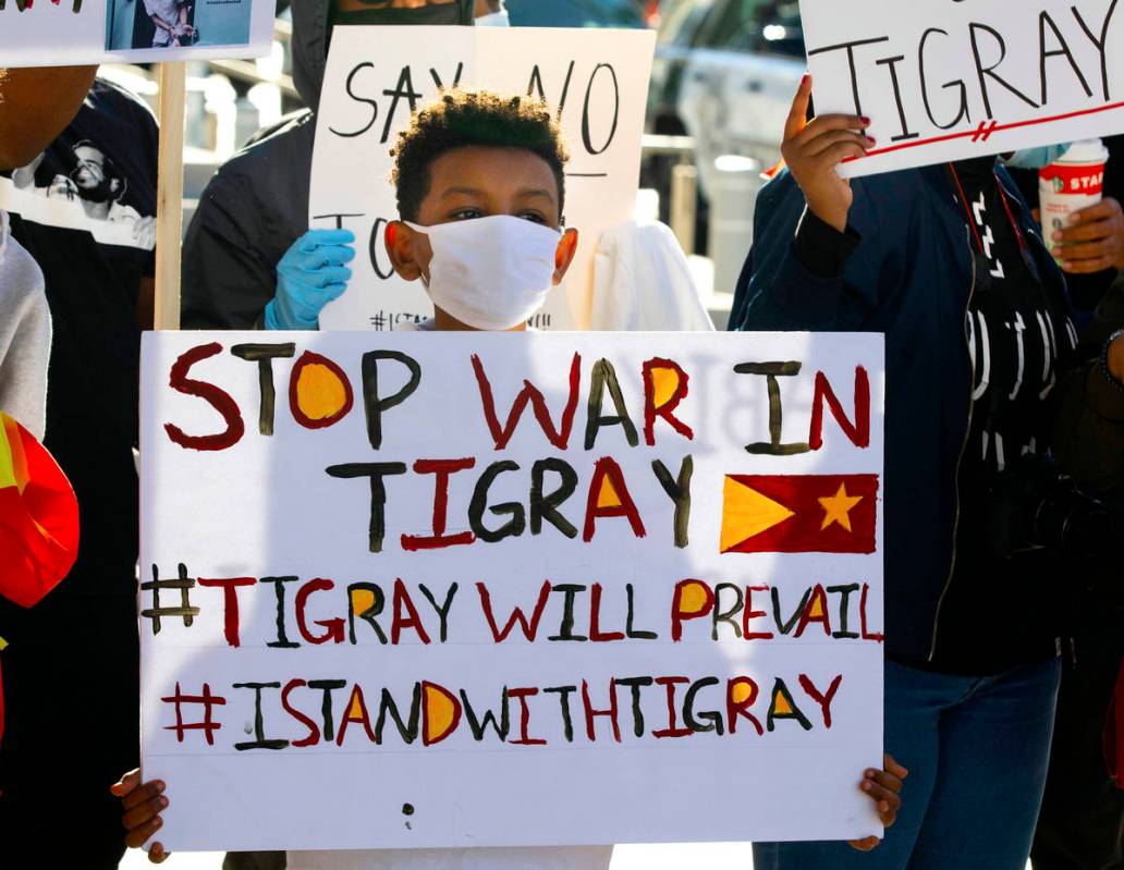 Yared Abraha, 11, holds a sign outside of the Lloyd D. George Federal Courthouse as he protests ...