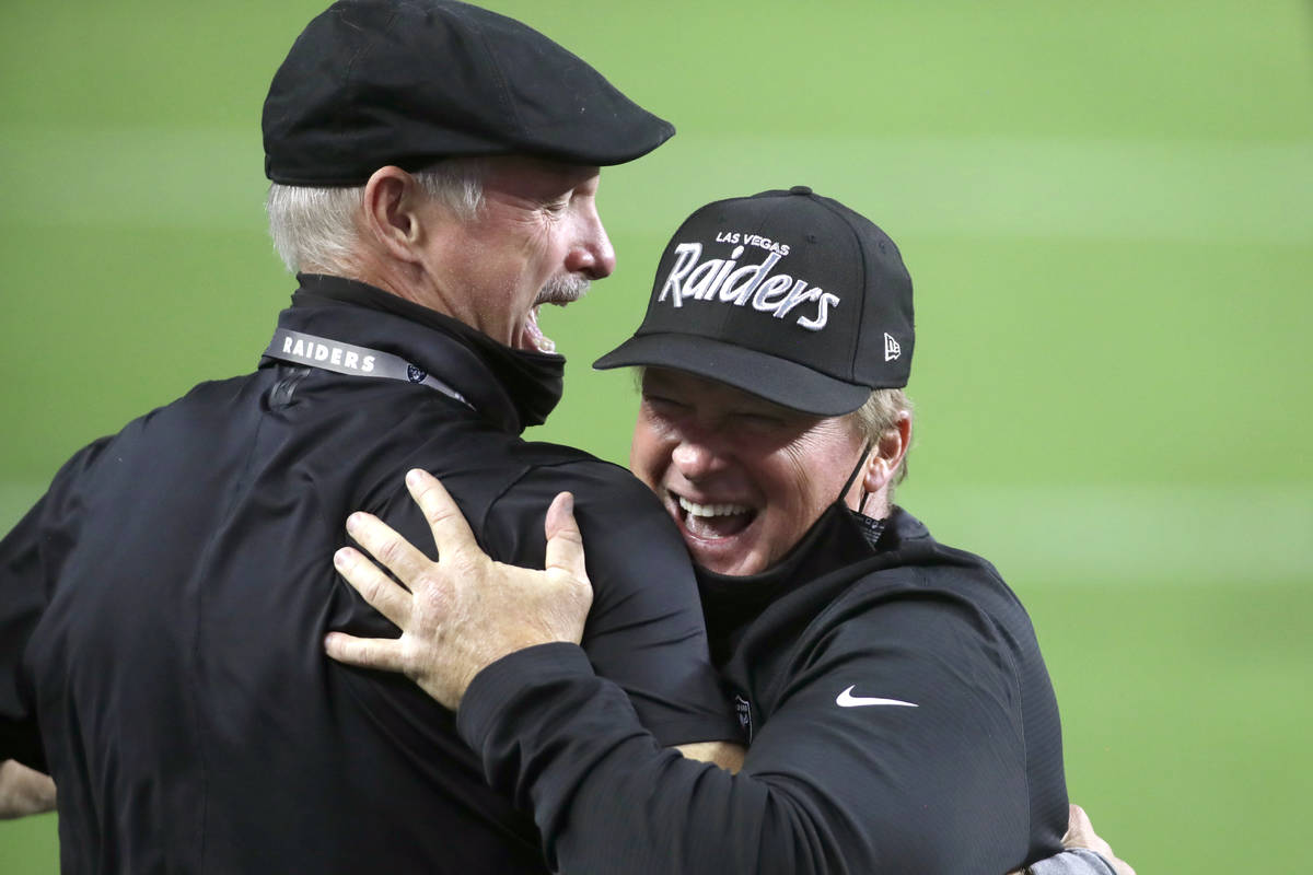 Las Vegas Raiders GM Mike Mayock, left, embraces head coach Jon Gruden after defeating the New ...