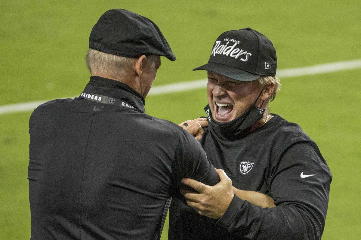 Las Vegas Raiders general Manager Mike Mayock, left, celebrates a win with head coach Jon Grude ...