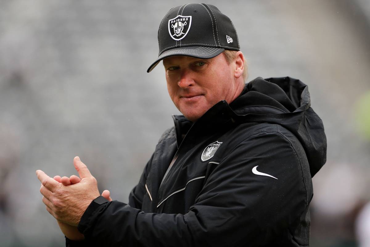 Oakland Raiders head coach Jon Gruden watches his team warm up before an NFL football game agai ...