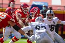 Las Vegas Raiders defensive ends Maxx Crosby (98) and Arden Key (99) pursue Kansas City Chiefs ...