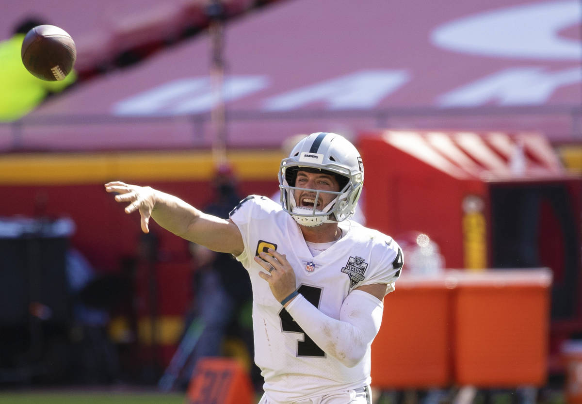 Las Vegas Raiders quarterback Derek Carr (4) makes a sideline pass in the fourth quarter during ...