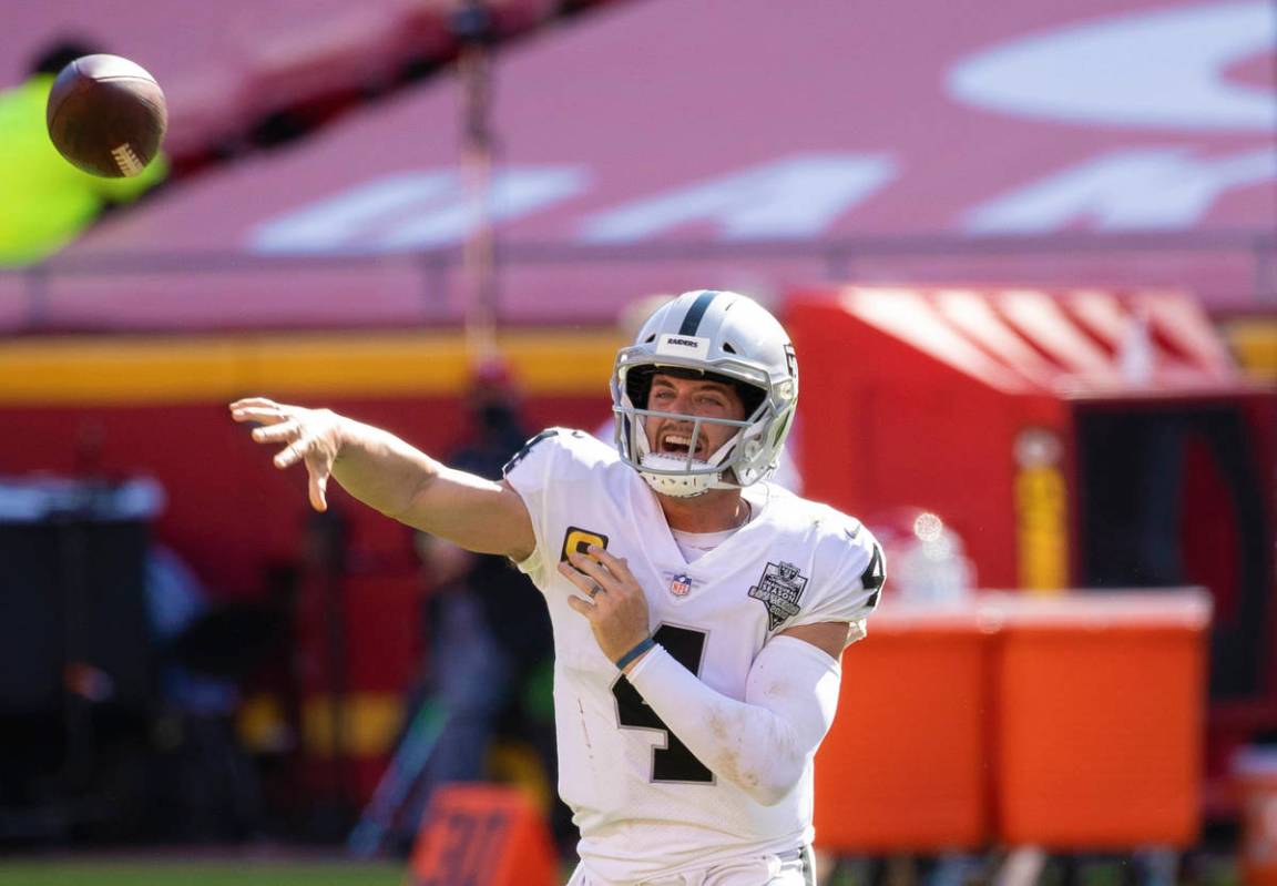 Las Vegas Raiders quarterback Derek Carr (4) makes a sideline pass in the fourth quarter during ...