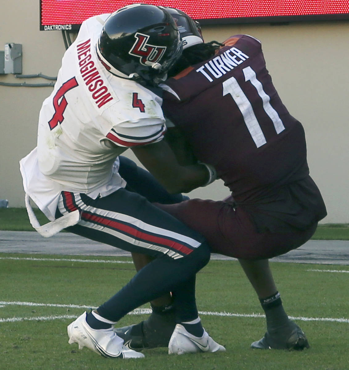 Virginia Tech's Tré Turner fights for a touchdown pass with Liberty's Chris Megginson duri ...