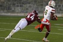 Mark Pope of Miami, right, runs towards the end zone for the game-winning score past Virginia T ...