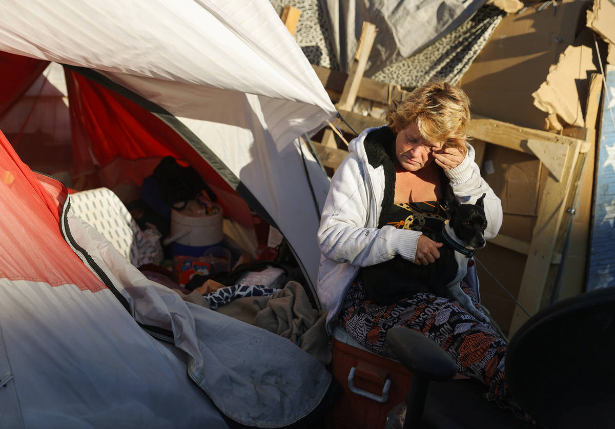 Faythe Simpson Zhang sits outside her tent after checking in with Help of Southern Nevada and t ...