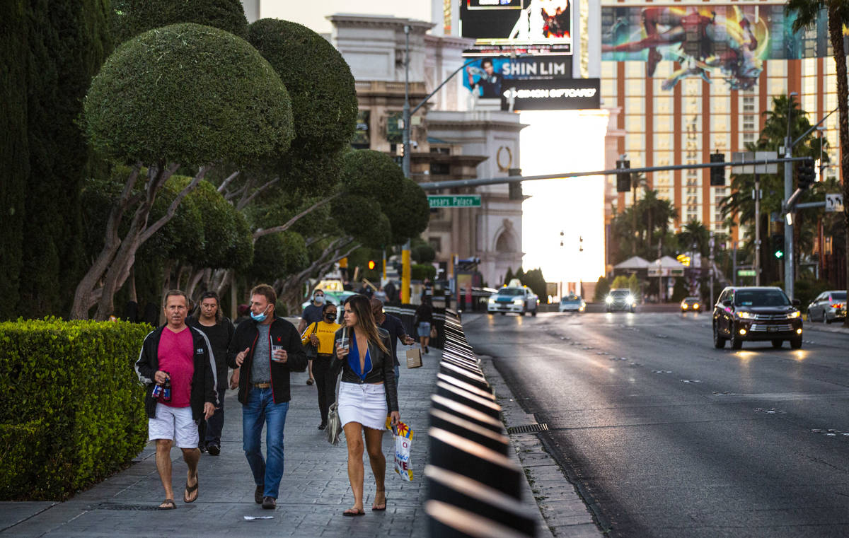 People walk along the Las Vegas Strip Thursday, Nov. 19, 2020. (Chase Stevens/Las Vegas Review- ...
