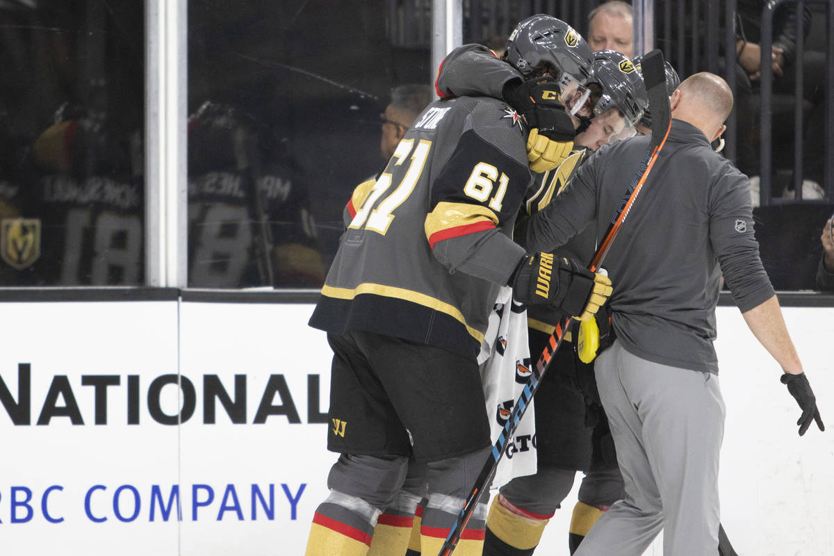 Golden Knights center Cody Glass (9) is carried off the ice by teammates Mark Stone (61) and Jo ...