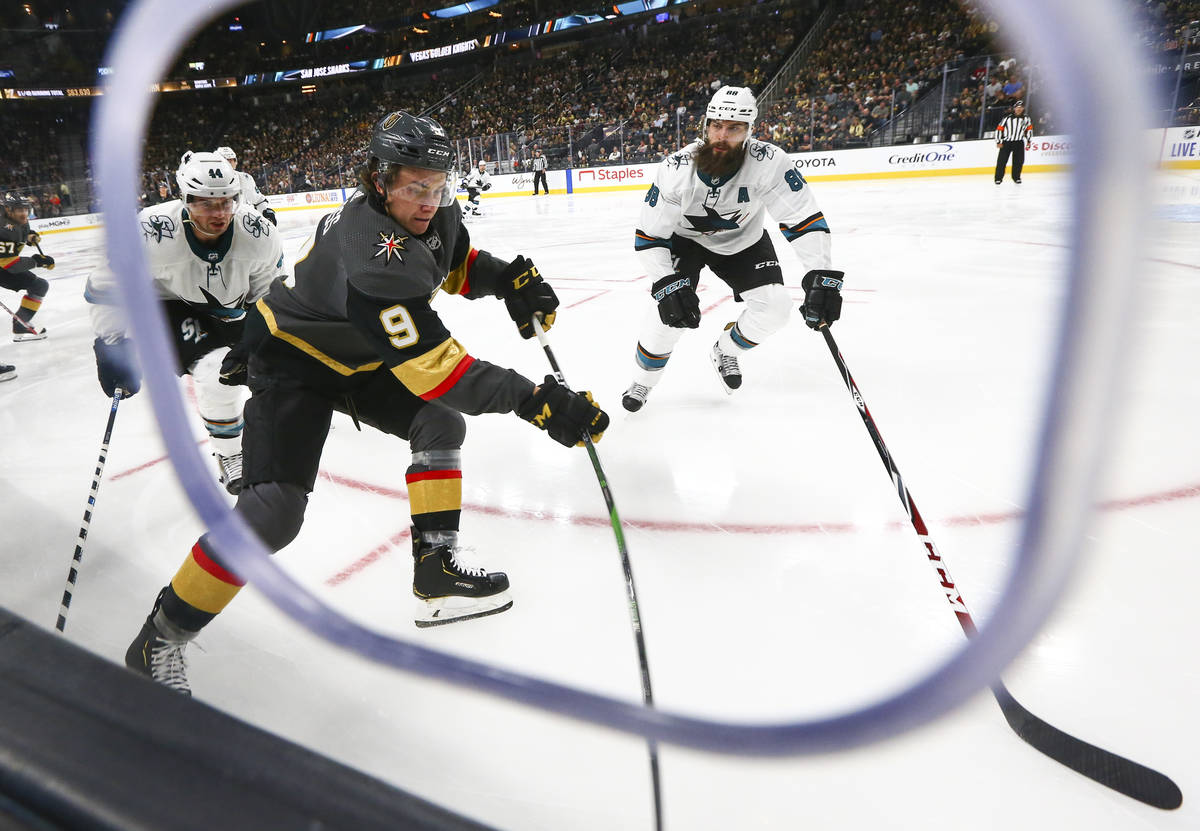 Golden Knights' Cody Glass (9) moves the puck against San Jose Sharks' Brent Burns (88) during ...
