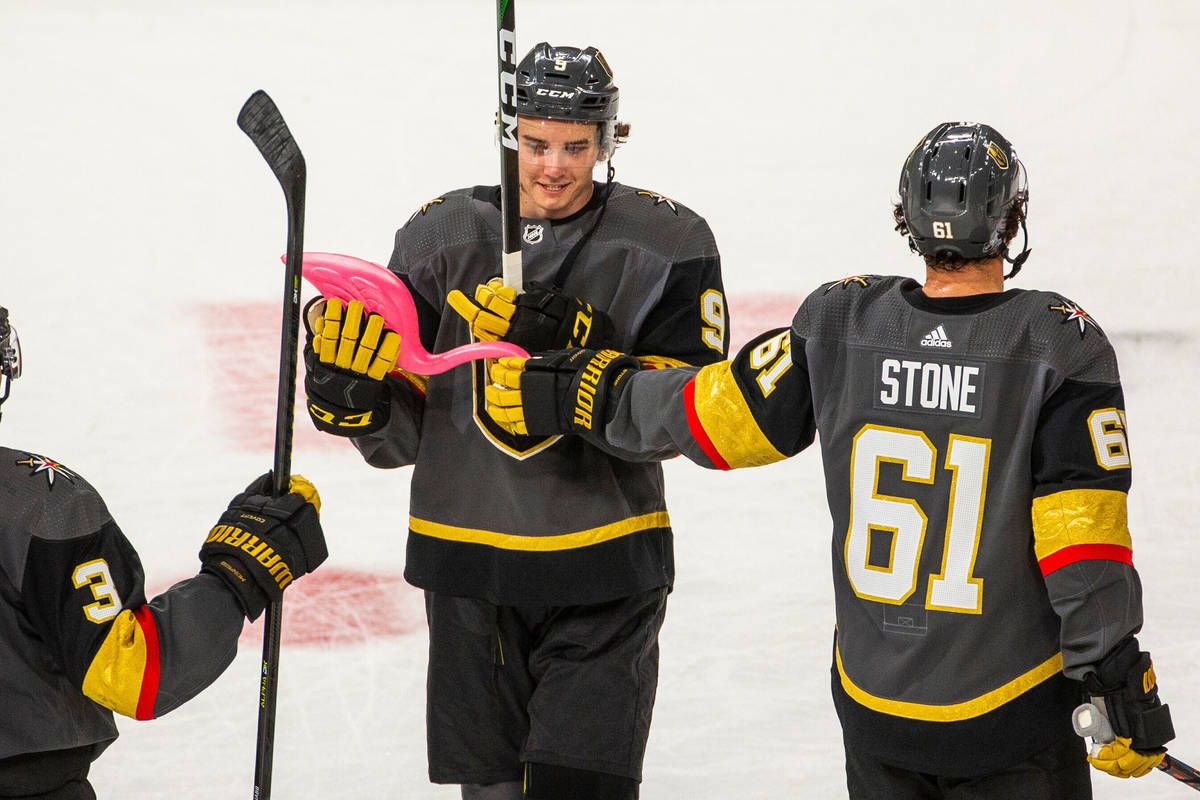 Vegas Golden Knights center Cody Glass (9) receives a pink flamingo from teammate right wing Ma ...