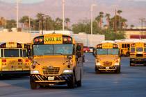 Drivers head out of the Clark County School District Arville Bus Yard in Las Vegas on the first ...