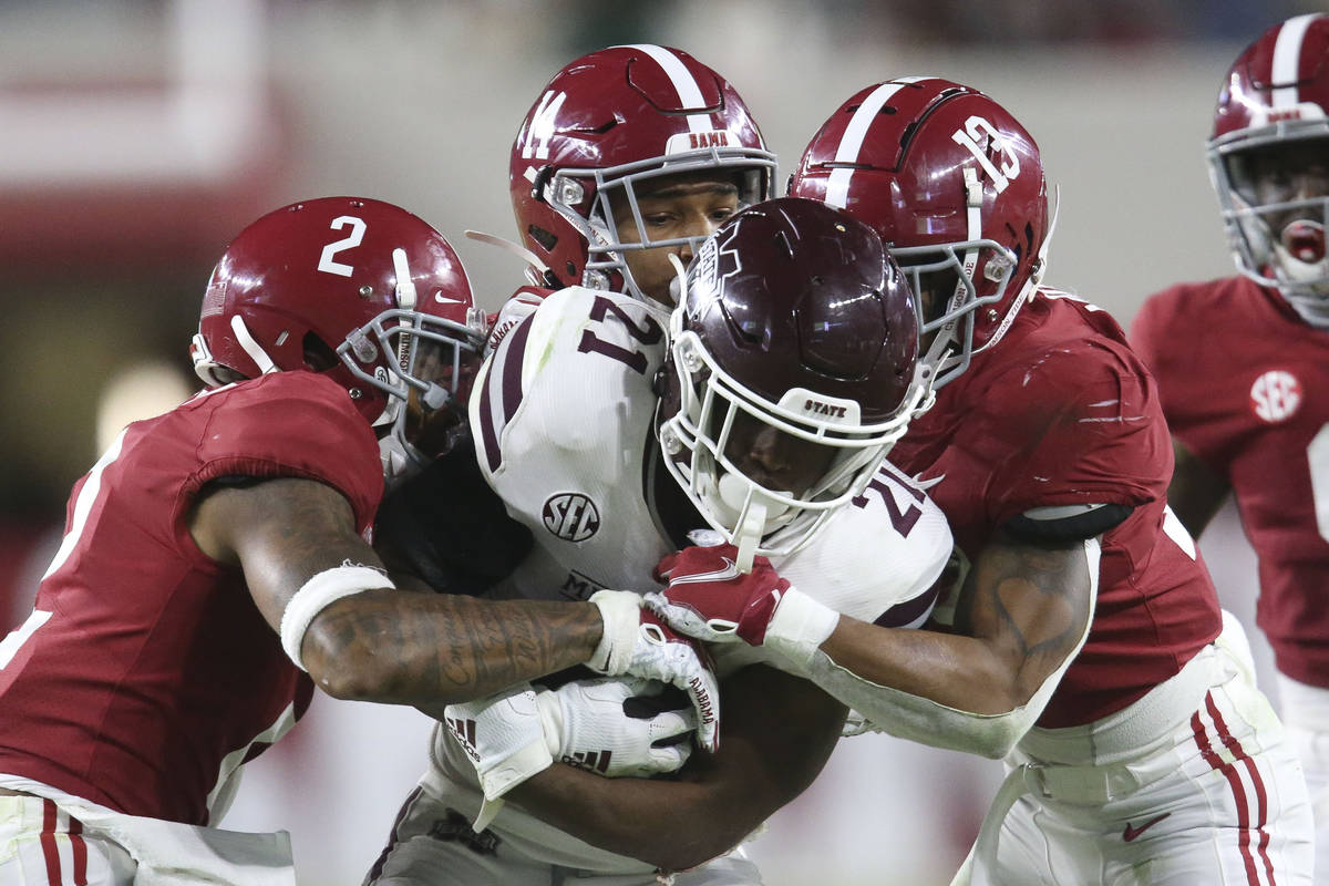 Alabama defensive back Patrick Surtain II (2), defensive back Brian Branch (14) and defensive b ...