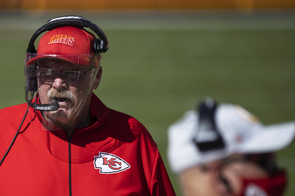 Kansas City Chiefs head coach Andy Reid, left, walks the sideline in the second quarter during ...