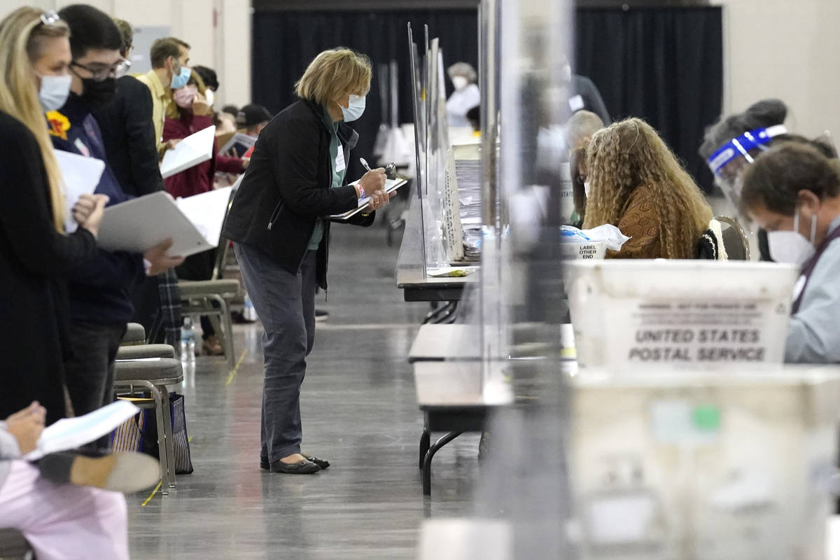 Recount observers watch ballots during a Milwaukee hand recount of Presidential votes at the Wi ...