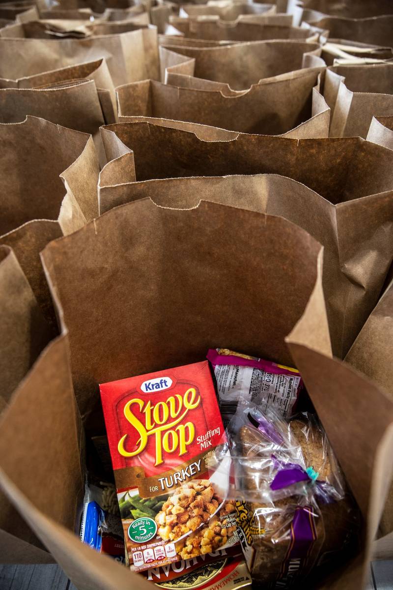 Bags of donated food wait to be handed out during a food drive hosted by Nectar Bath Treats on ...