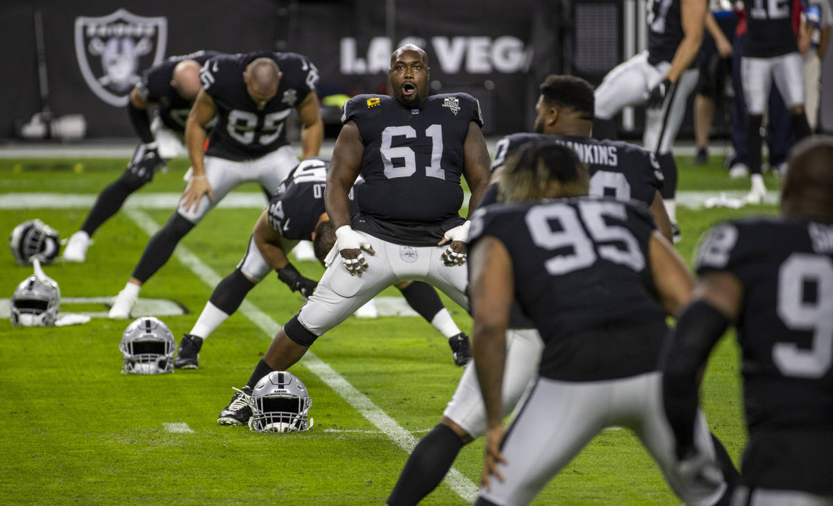 Las Vegas Raiders center Rodney Hudson (61) and teammates warm up before the start of their NFL ...