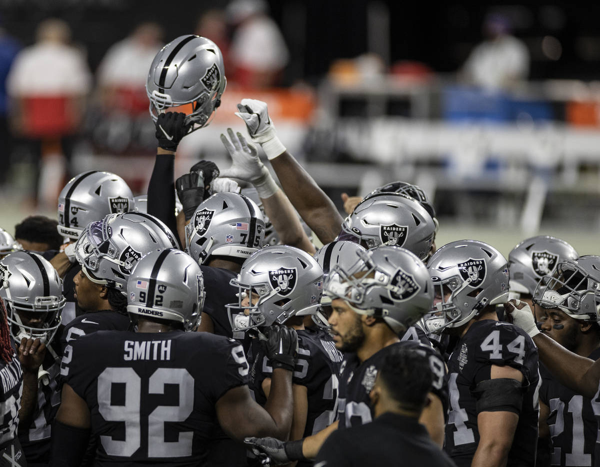 The Las Vegas Raiders warm up before the start of an NFL football game against the Kansas City ...