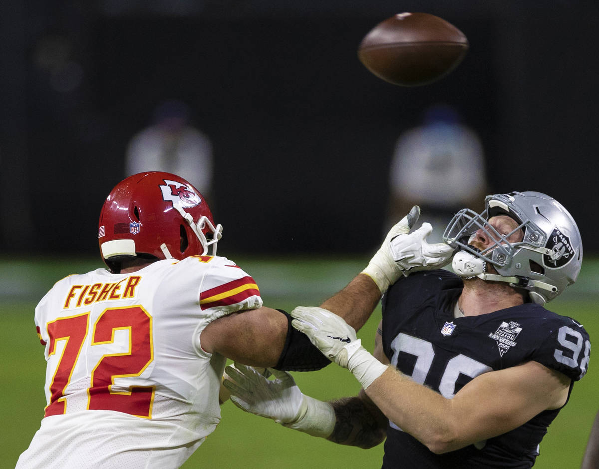 Las Vegas Raiders defensive end Maxx Crosby (98) hand fights with Kansas City Chiefs offensive ...