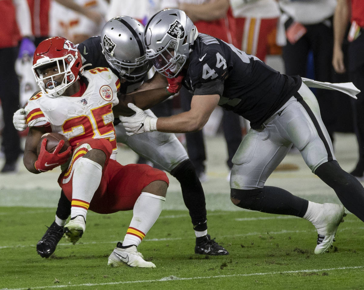 Kansas City Chiefs running back Clyde Edwards-Helaire (25) is tackled by Las Vegas Raiders insi ...