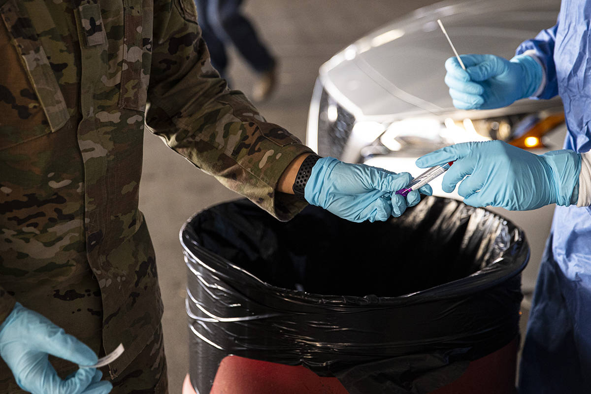 Nevada National Guard specialists Jonathan Macias, left, and Demetrie Barnett prepare to store ...