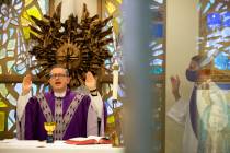 Msgr. Gregory Gordon, left, gives a virtual Mass at the The Roman Catholic Diocese of Las Vegas ...