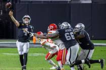 Las Vegas Raiders quarterback Derek Carr (4) gets off a pass under pressure by the Kansas City ...