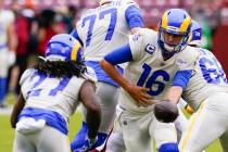 Los Angeles Rams' Jared Goff (16) hands off to Darrell Henderson (27) during the first half of ...